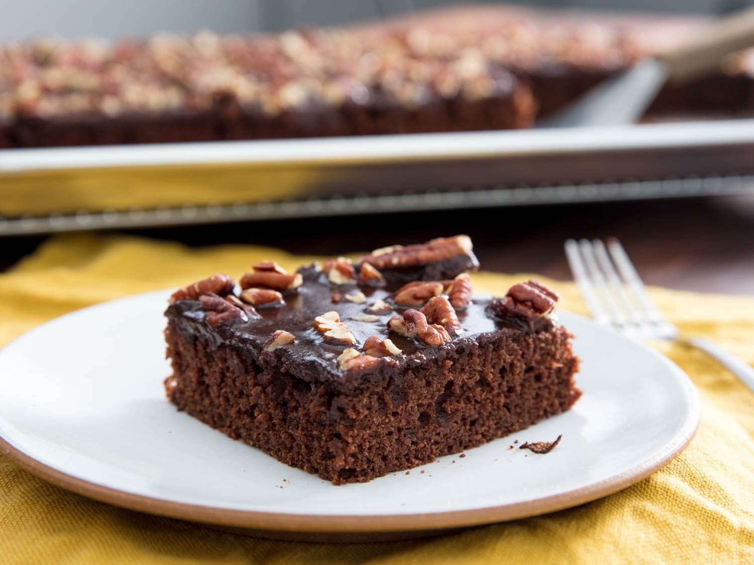A square of Texas sheet cake on a white plate.