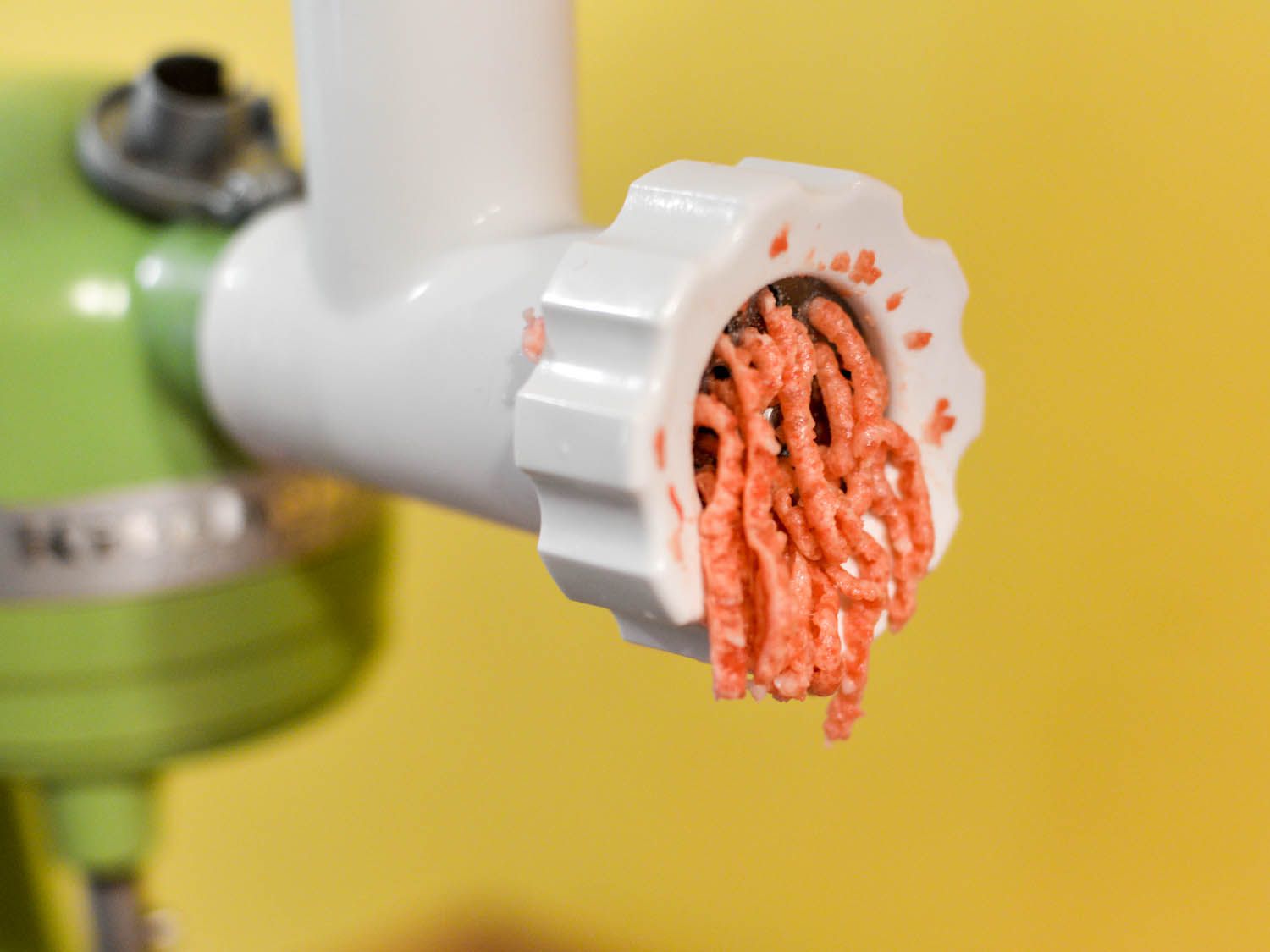 Meat for sheftalia is ground with a KitchenAid food grinding attachment.