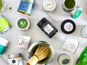 Numerous matcha powders on a marble countertop.