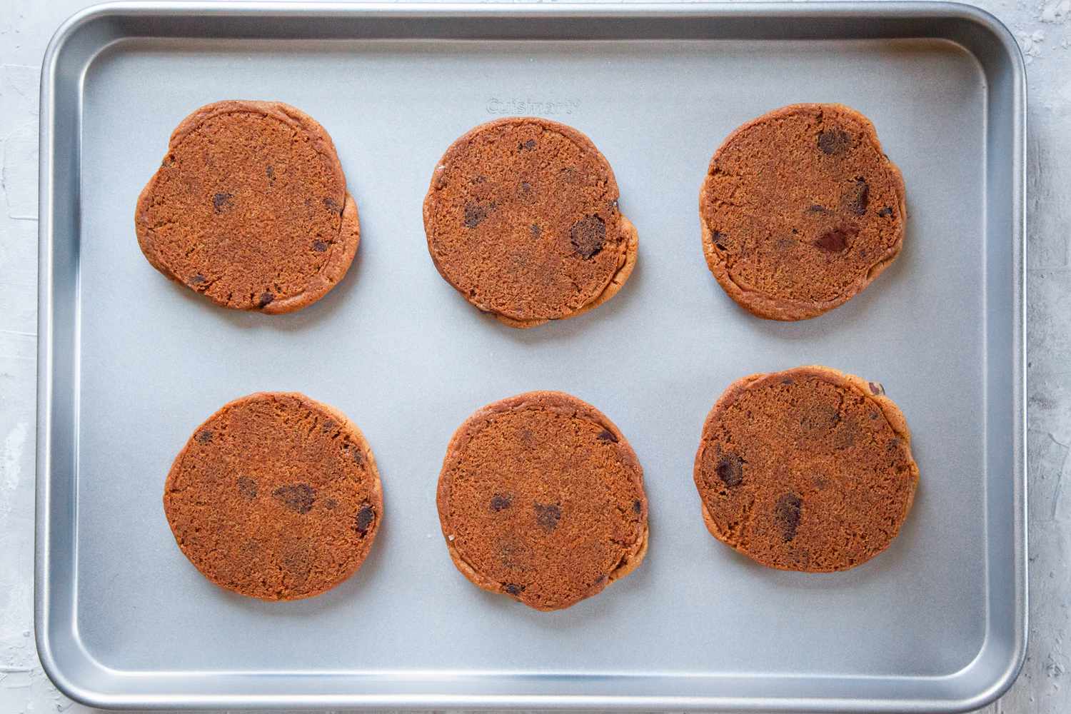 Upside-down cookies on a sheet pan
