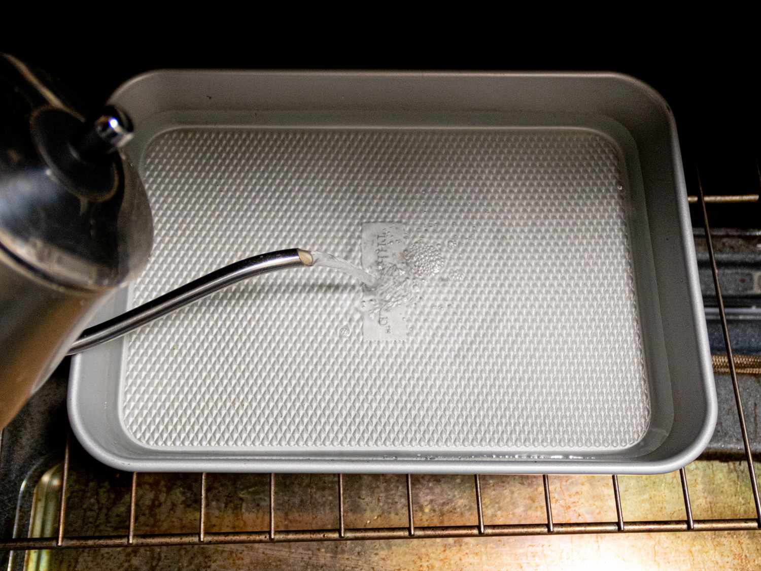 Overhead view of filling tray with boiling water