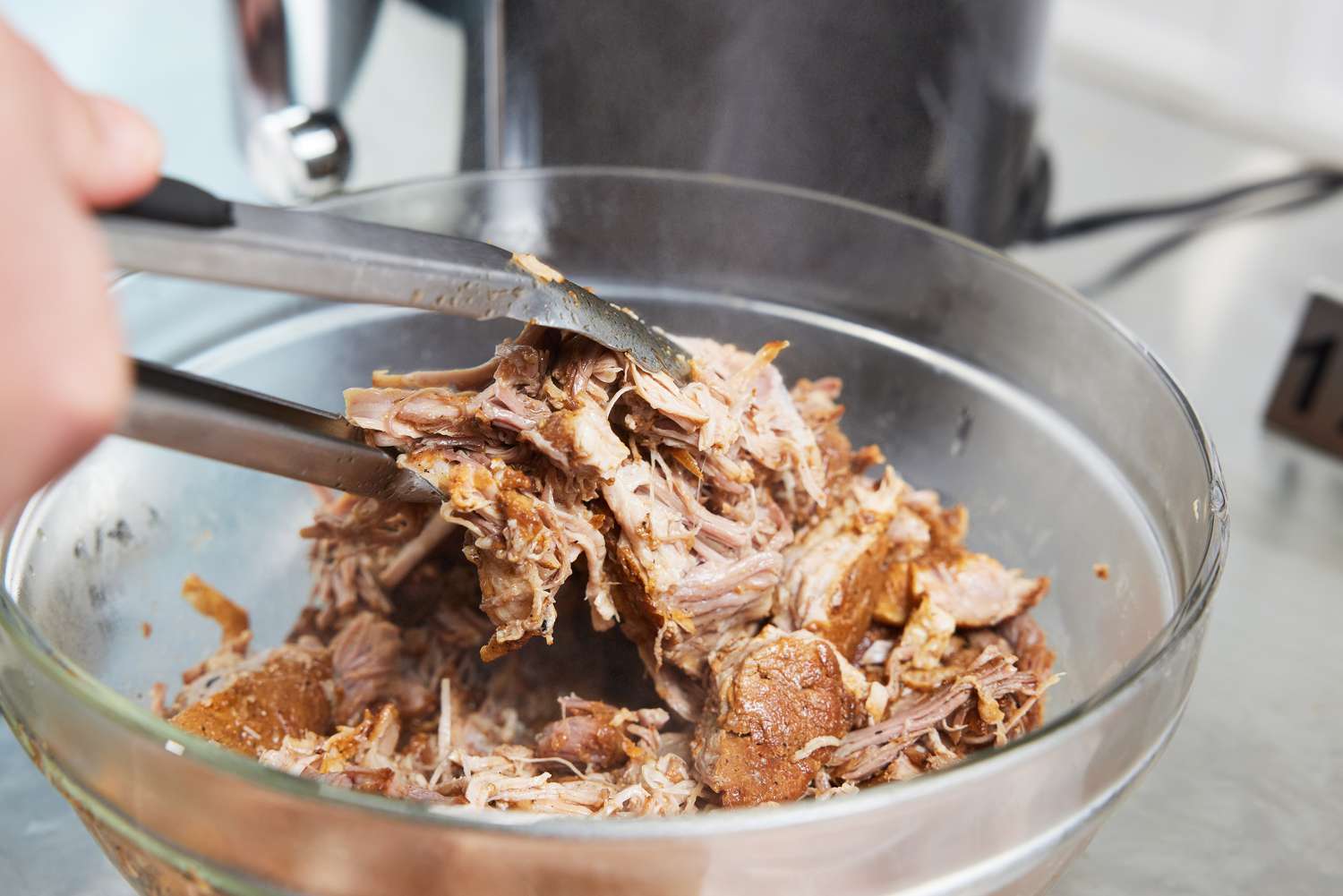 Person preparing meat on bowl beside that Instant Pot Pro Plus Wi-Fi Smart 10-in-1 6-Quart Pressure Cooker 