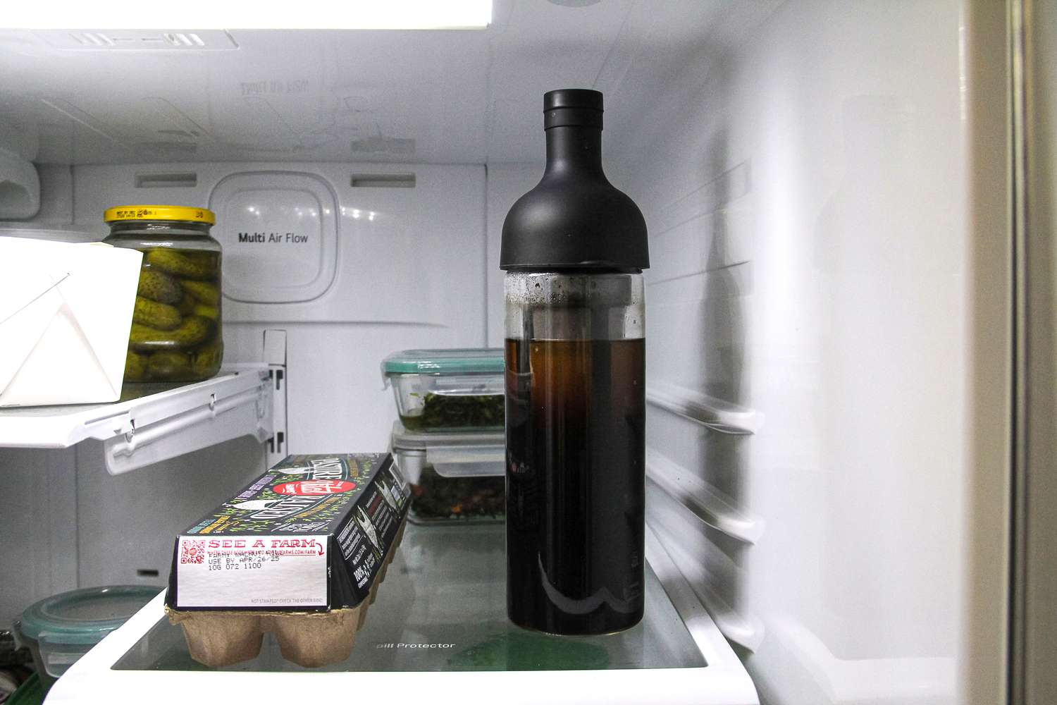A cold brew maker on a fridge shelf.