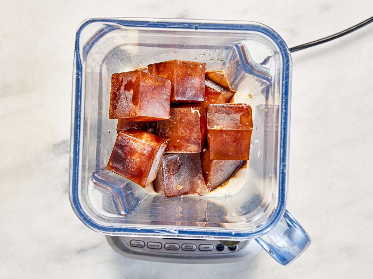 Overhead view of coffee ice cubes in blender