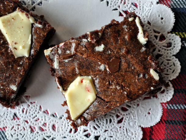 Closeup of a peppermint bark brownie on a paper doily.
