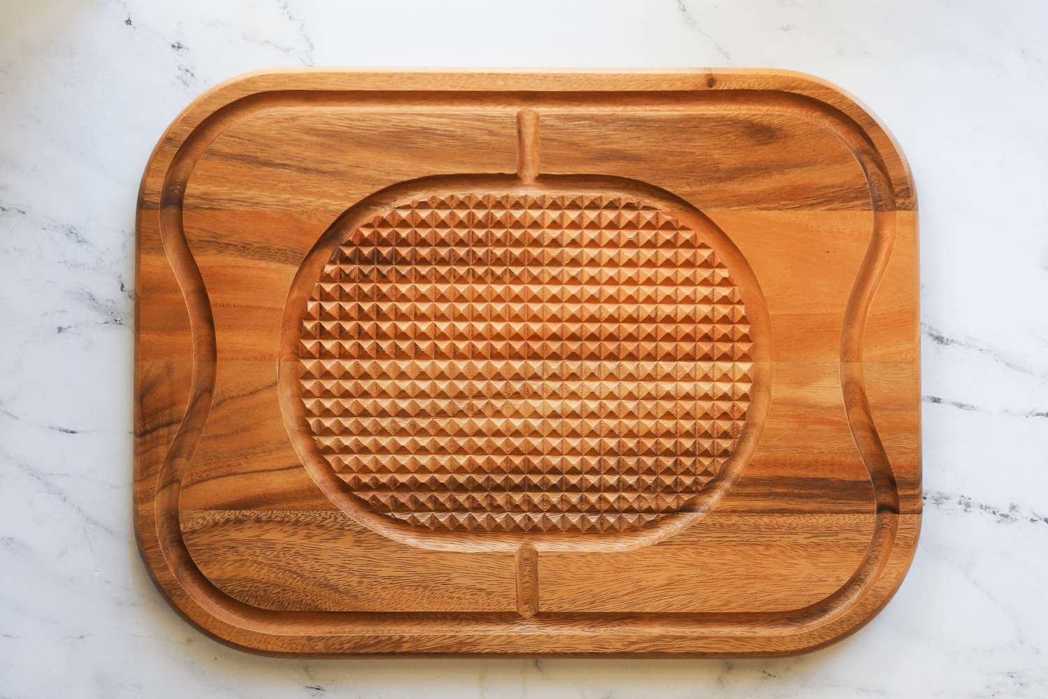 Lipper International Acacia Cutting Board with Grid Grip placed on floor