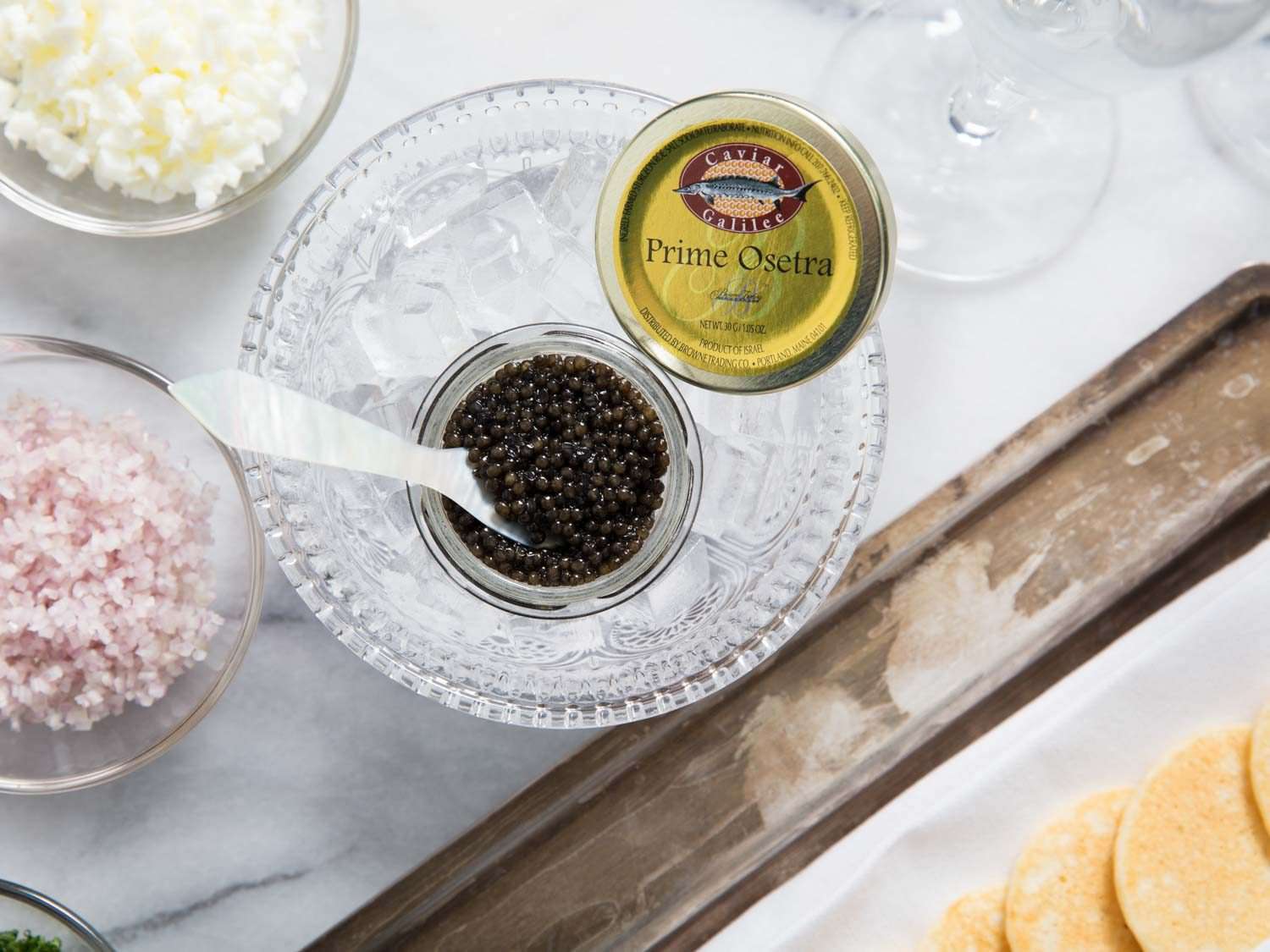 Close-up of jar of prime osetra caviar in set in a bowl of ice