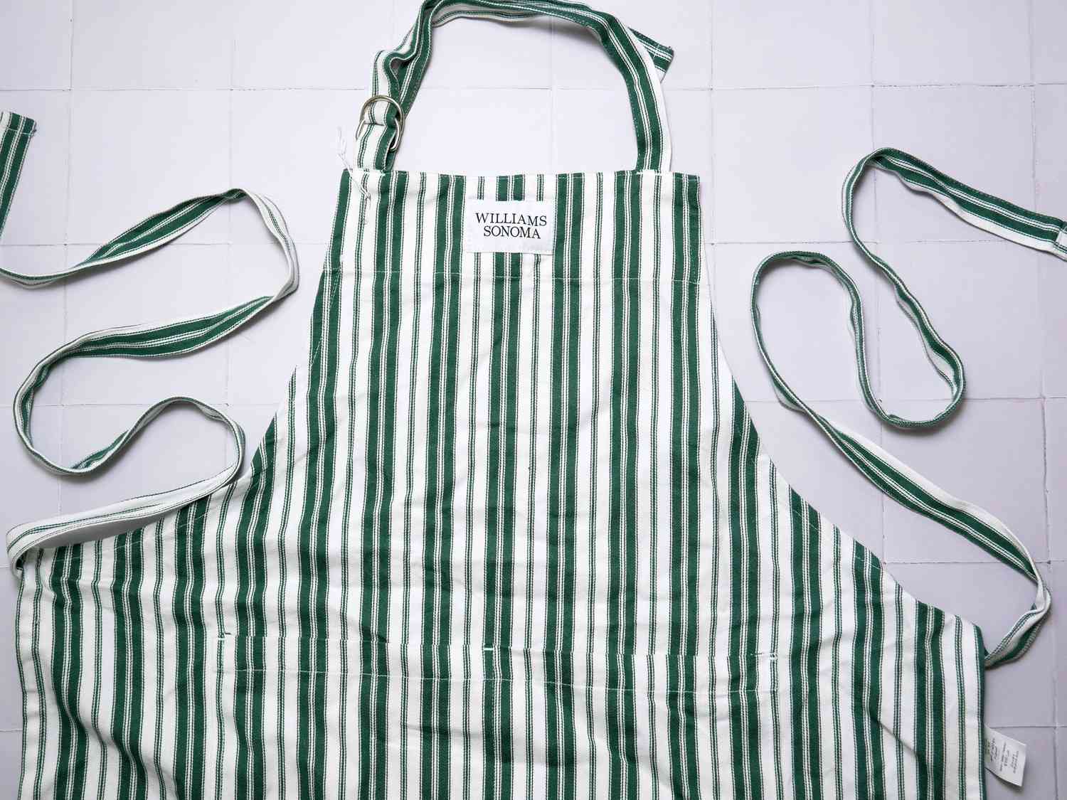 williams sonoma apron on a white tile background