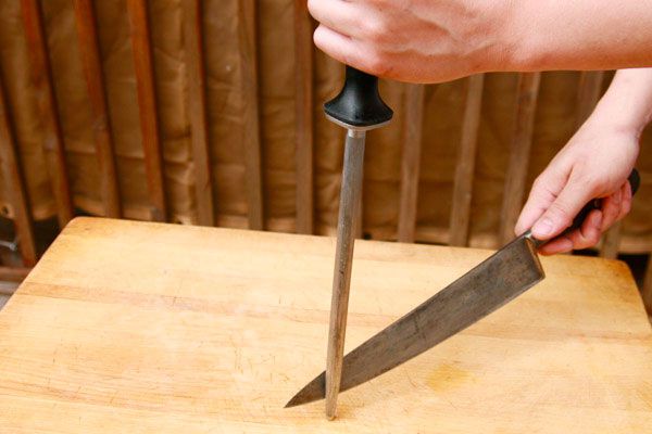 Author has slid the blade down the honing steel, which is now touching the steel near the tip of the blade.