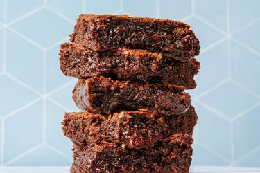 Stacked fudgy brownies with a geometric background