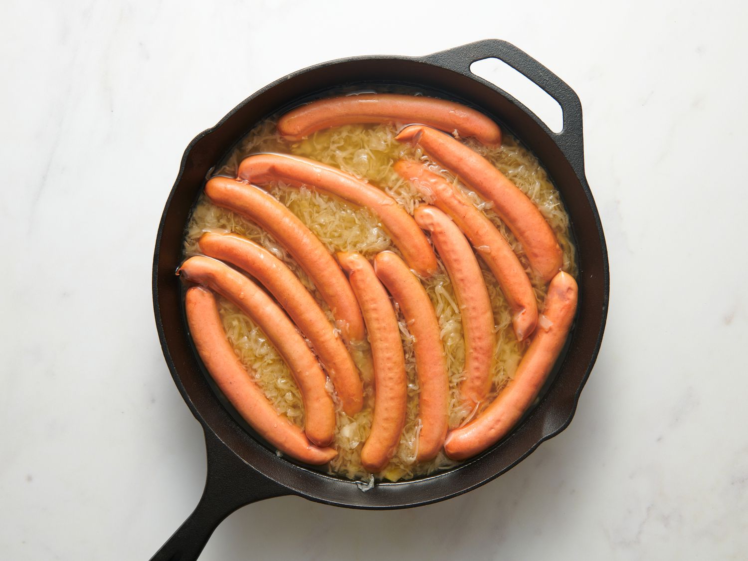 Overhead view of hot dogs in sauerkraut