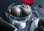 two scoops of black sesame ice cream in glass coupe