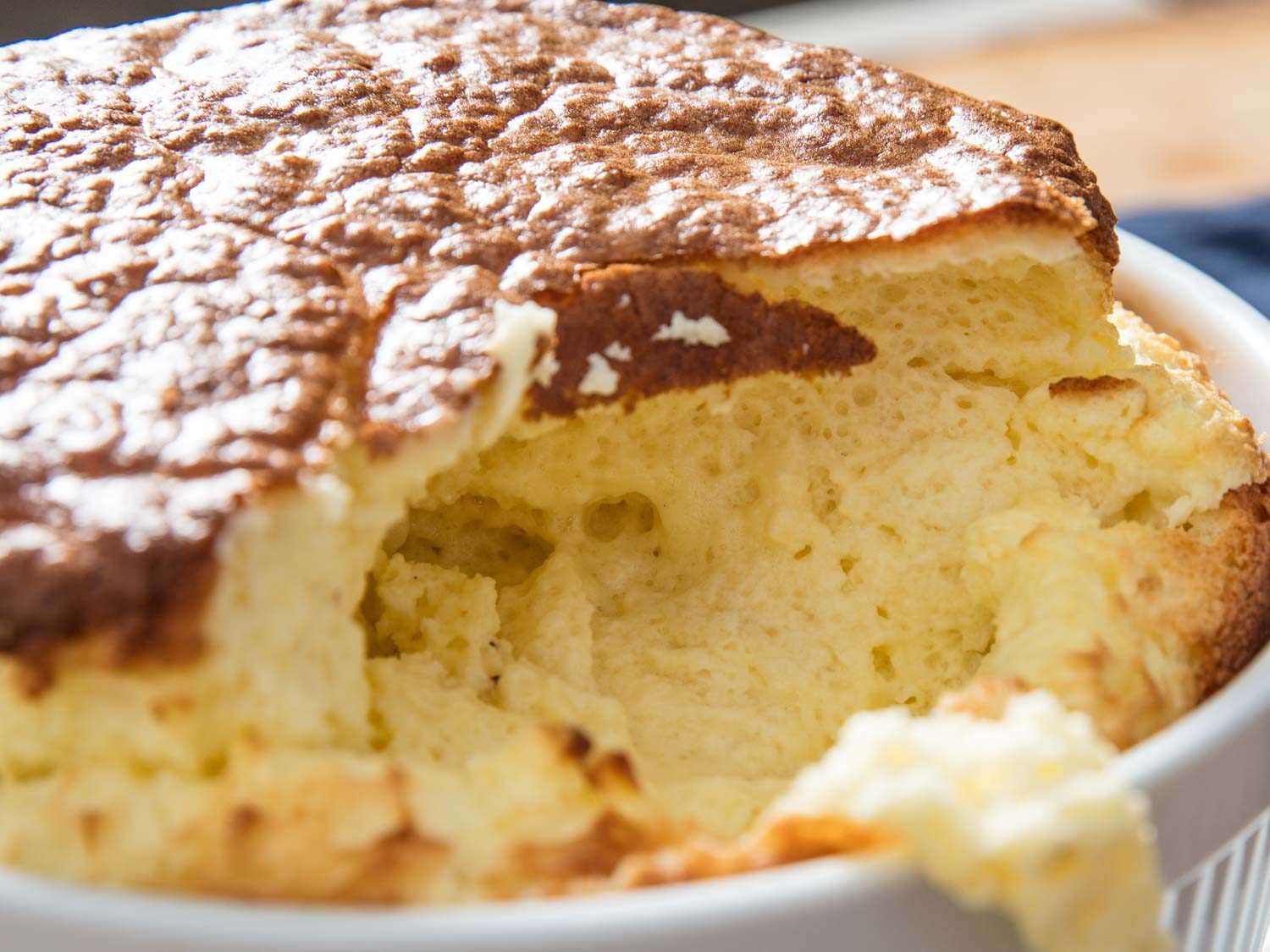 Looking inside a cheese soufflé baked at a lower temperature for a longer time that is fully cooked through the center.