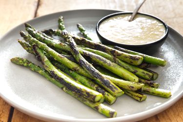 Dry-charred asparagus, served on an earthenware plate with a ramekin of miso bearnaise.