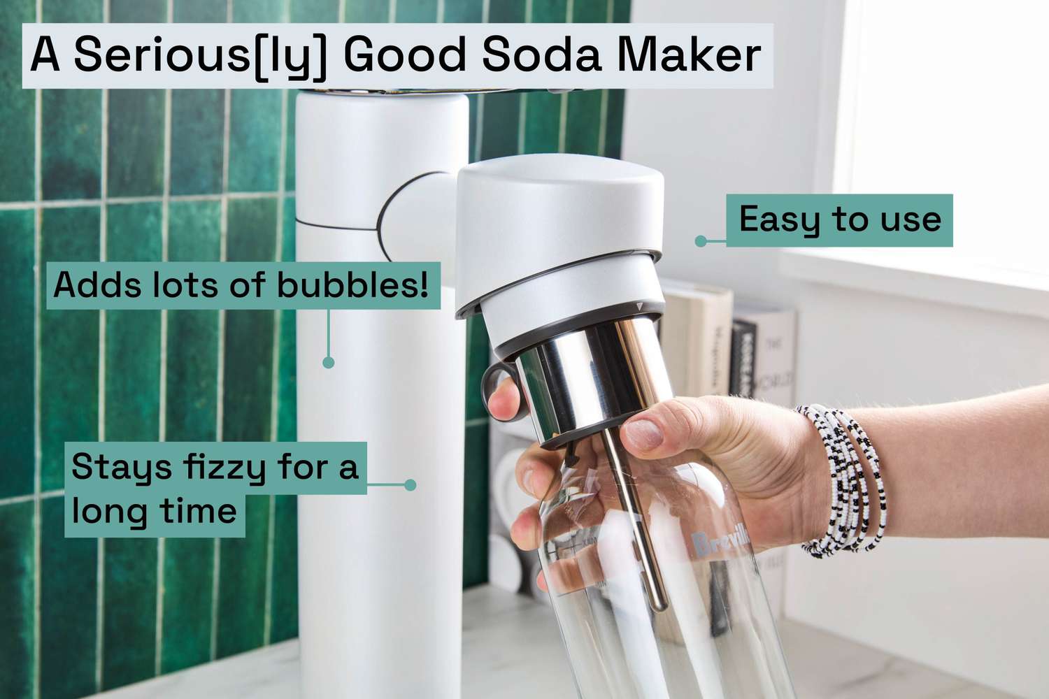 a person holding the bottle of a soda maker