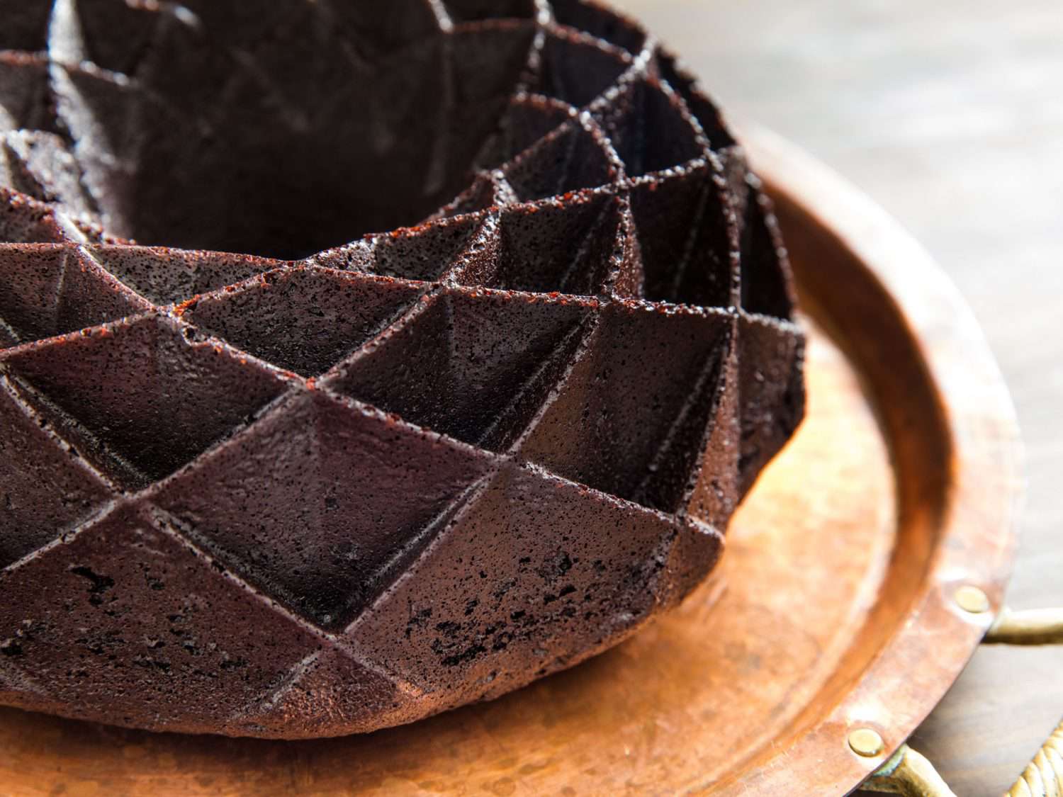 Closeup of a chocolate bundt cake baked in a Nordicware Jubilee bundt pan.
