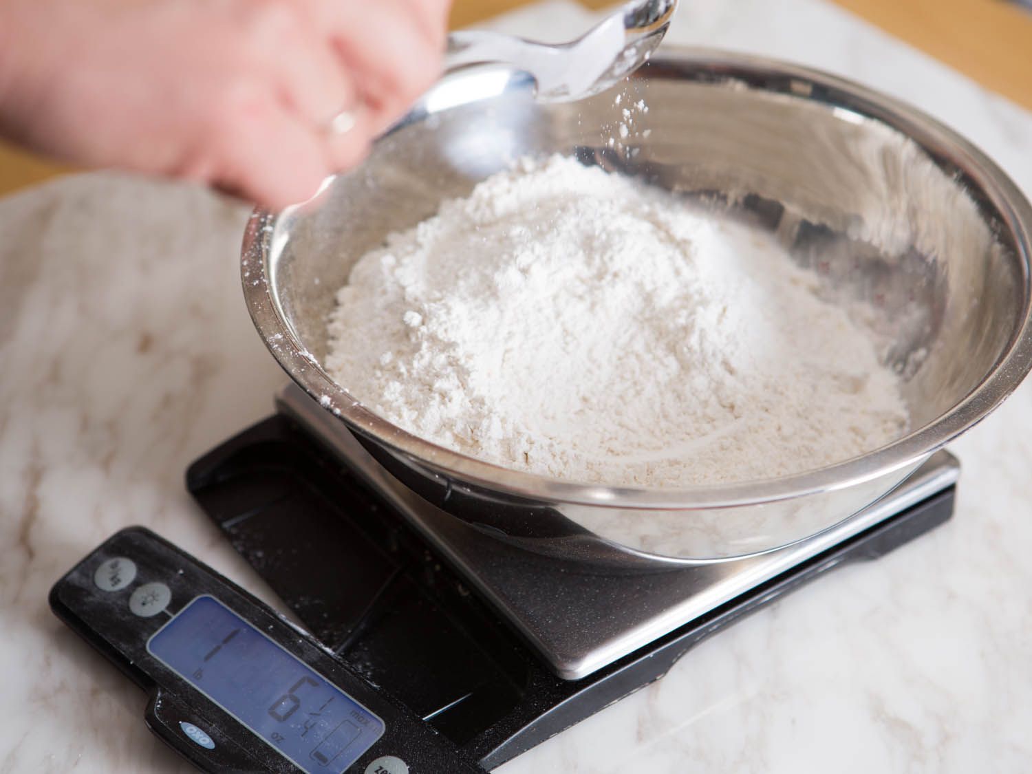Flour is added to the mixing bowl.