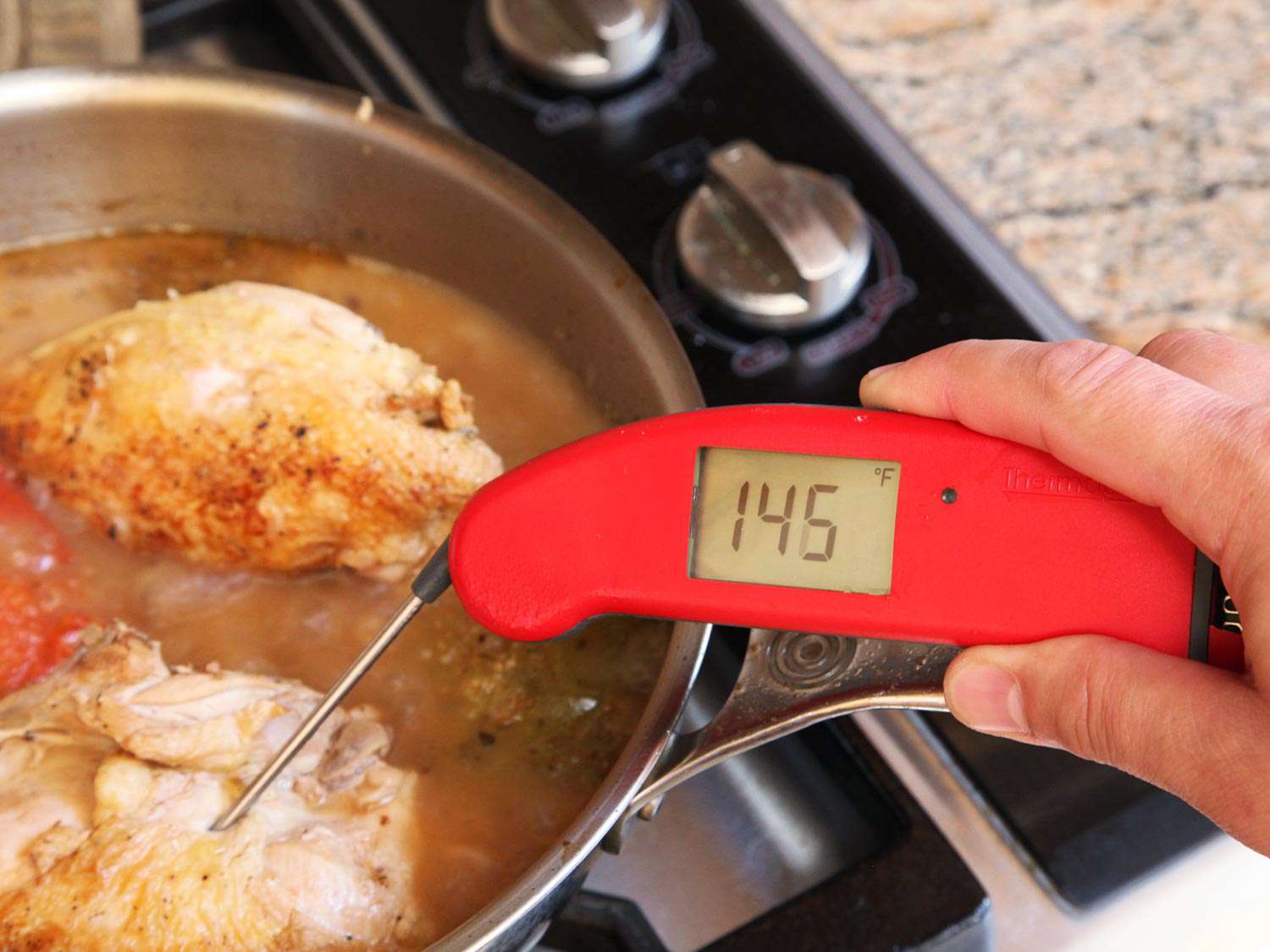Taking temperature of the chicken for chicken tinga. The thermometer registers 145 degrees Farenheit. 
