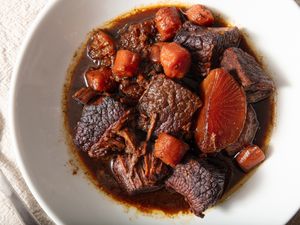 white dish of Cantonese braised brisket on a white tablecloth