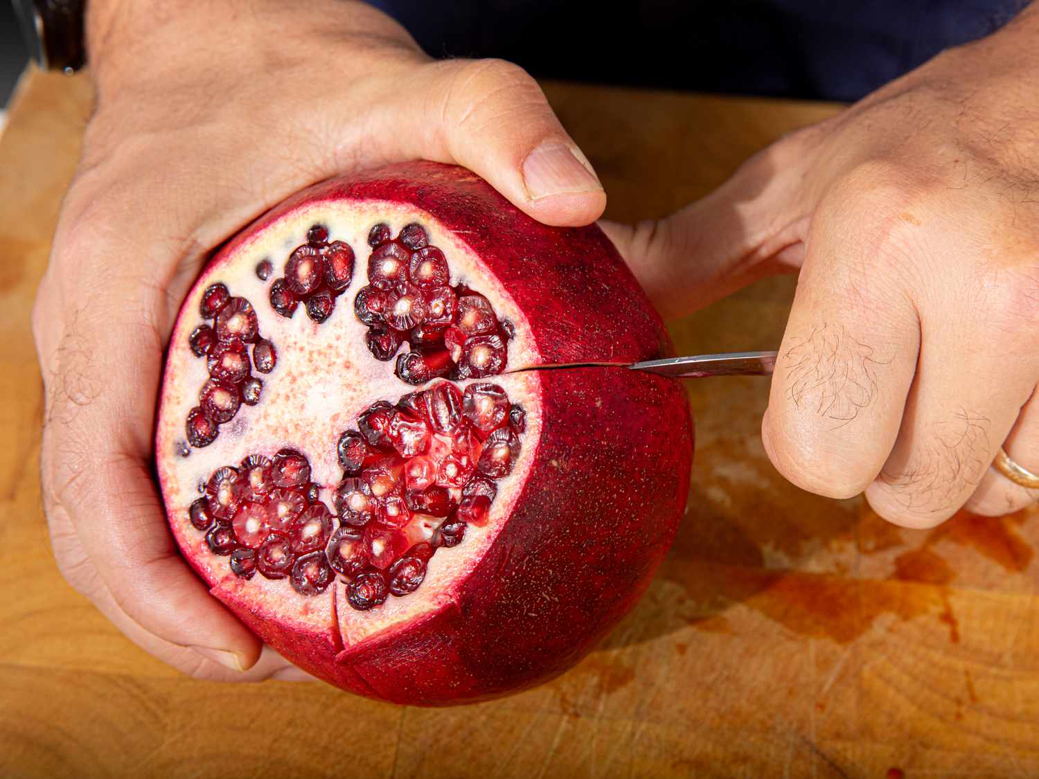 Cutting pomegranate into sections 