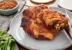 A Thai-inspired slow-roasted pork shoulder served on a gray platter.