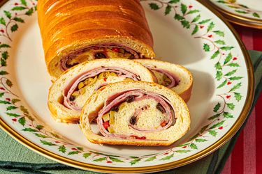 Pan de jamn on a decorative plate with slices showing the filling