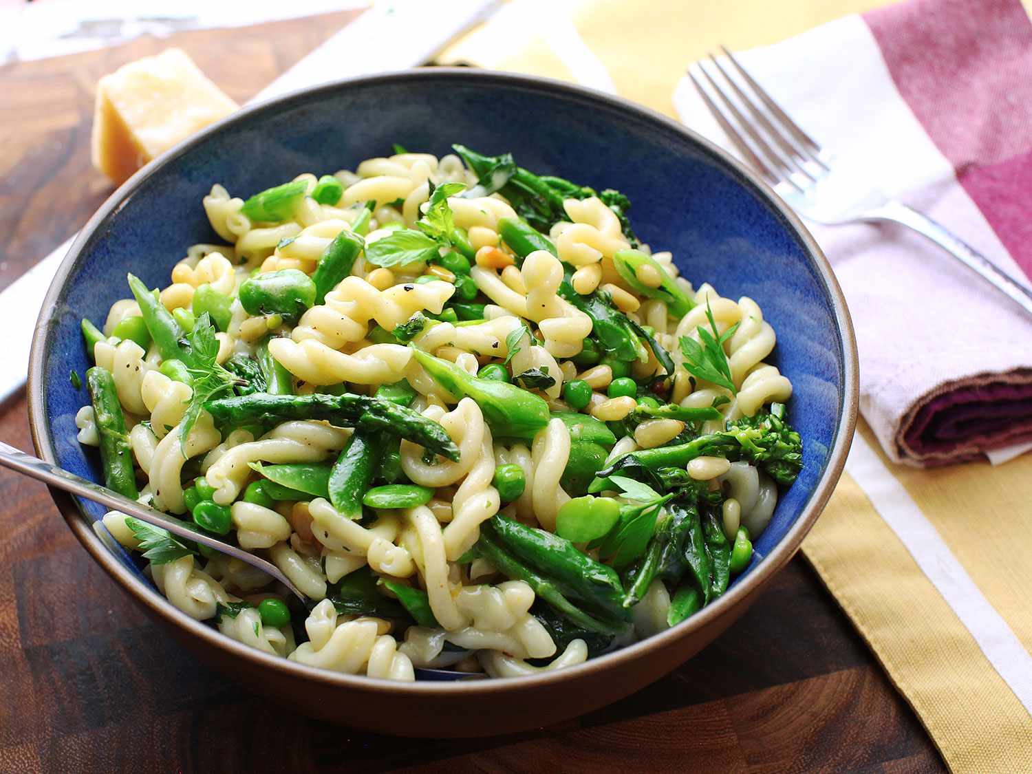 The finished pasta primavera, served in a blue ceramic bowl.
