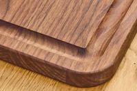 Closeup view of the corner of a Virginia Boys Kitchens Walnut Wood Cutting Board