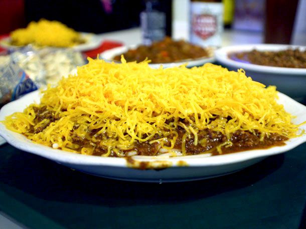 A plate of Cincinnati-style chili, served on cooked spaghetti and blanketed with a robust layer of shredded medium cheddar cheese (known as a "3-way").