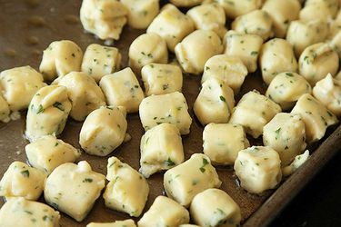 A baking sheet with Parisian Gnocchi resting on top 