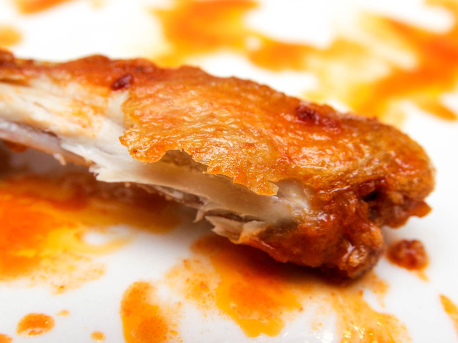 Closeup of bite taken out of buffalo wing