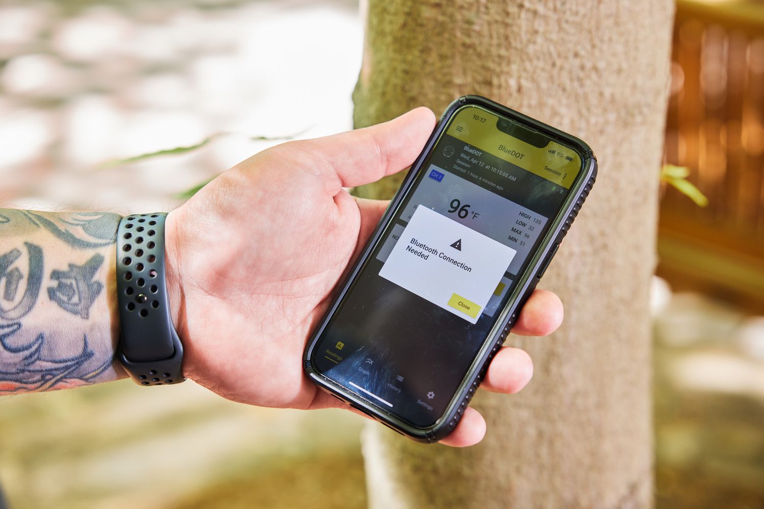 a person using a phone app to connect to a thermometer