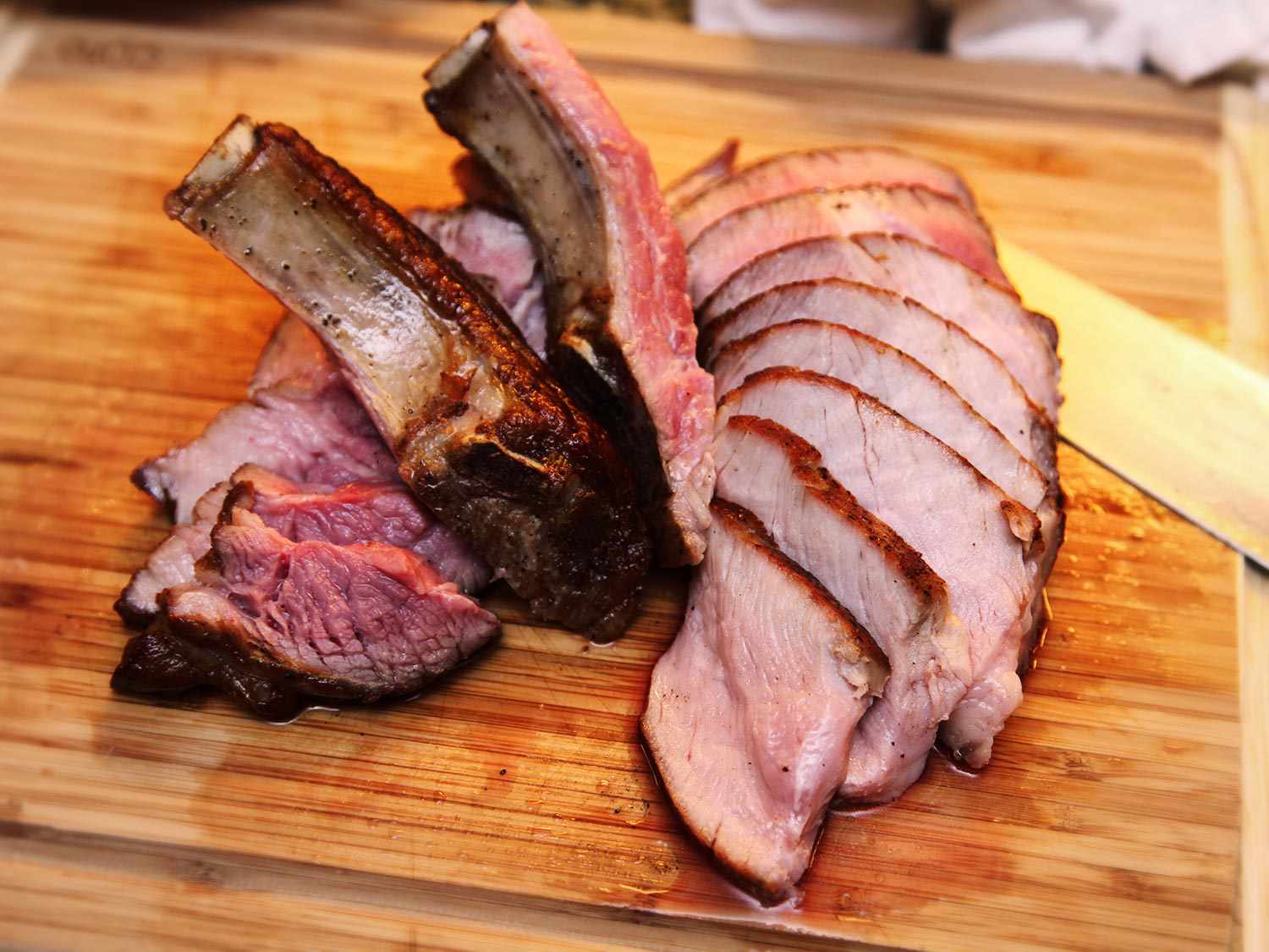 Juicy sliced double-cut pork chop displayed on a cutting board