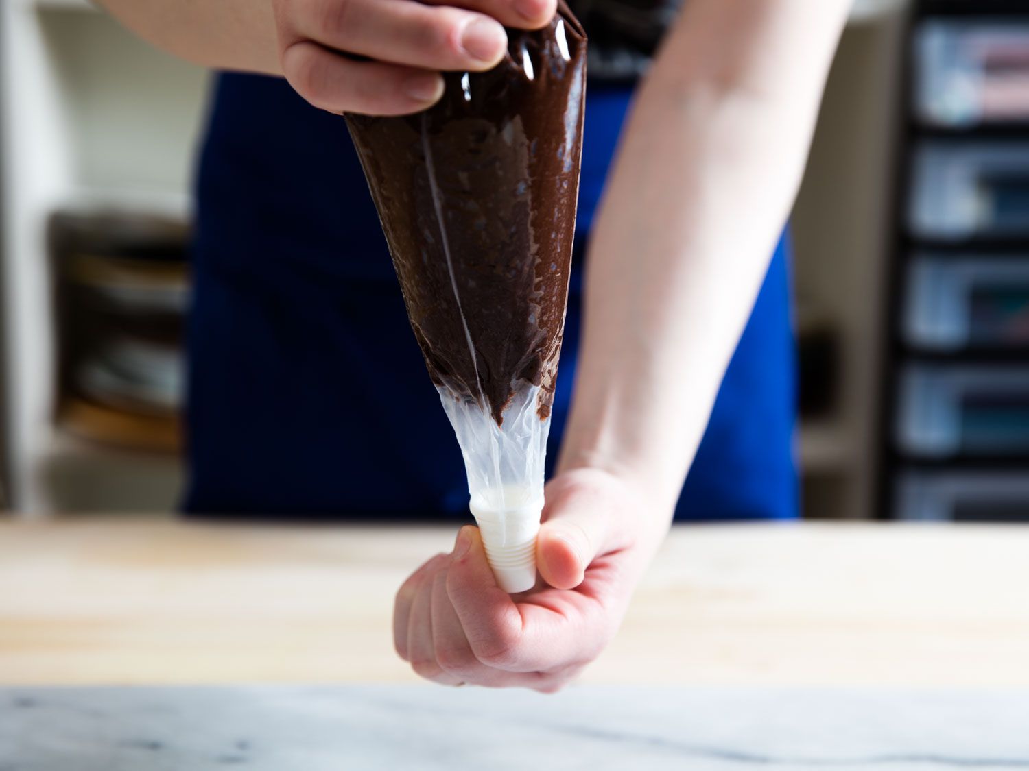 Author twists the tip end of the bag open.