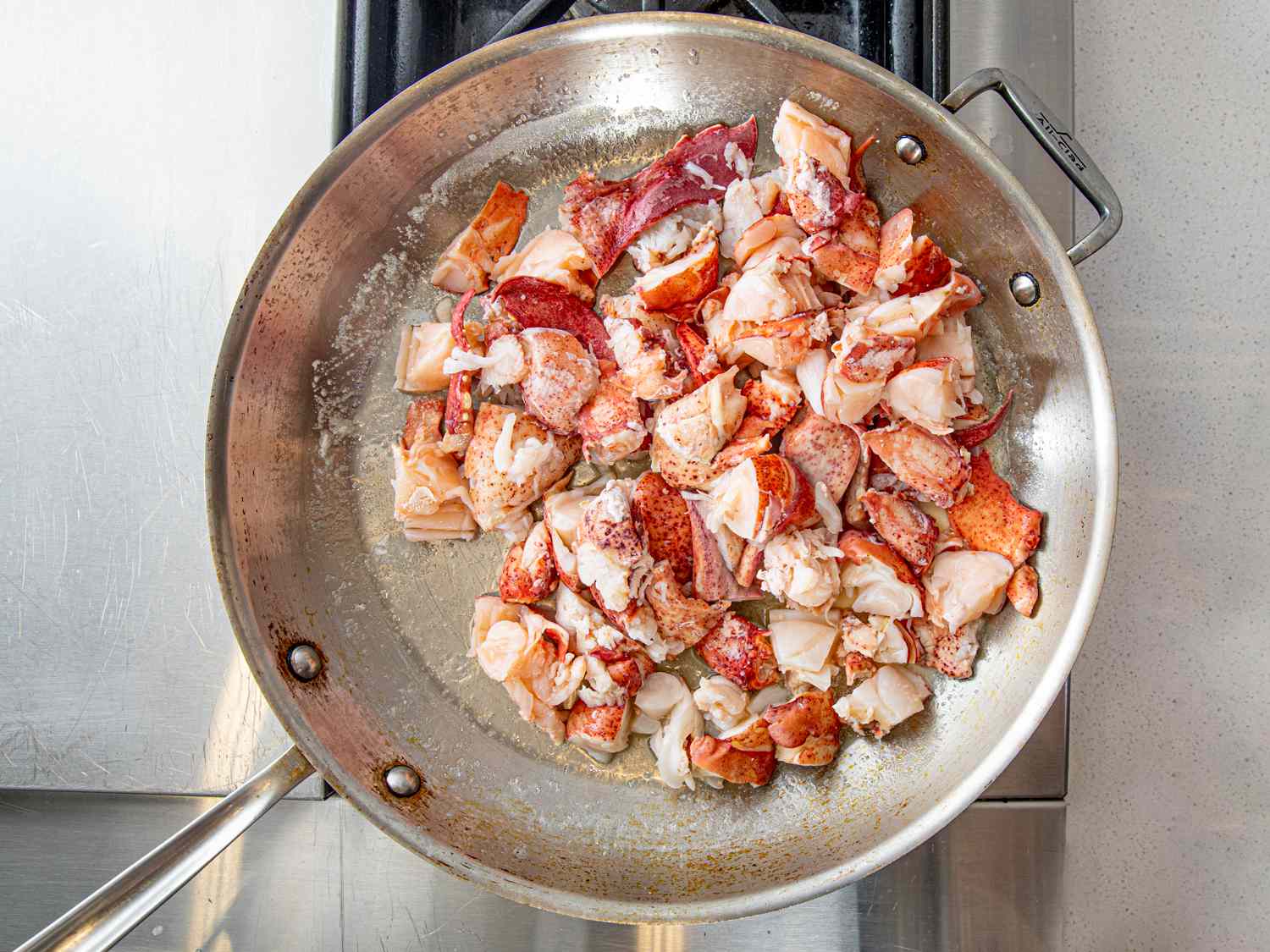 Lobster cooking in a pan with butter