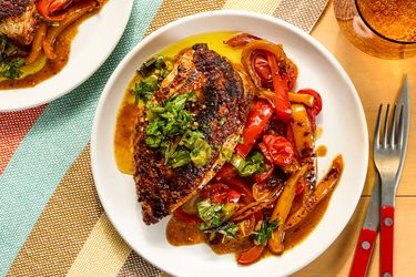 Grilled chicken with sauted vegetables and garnish on a plate