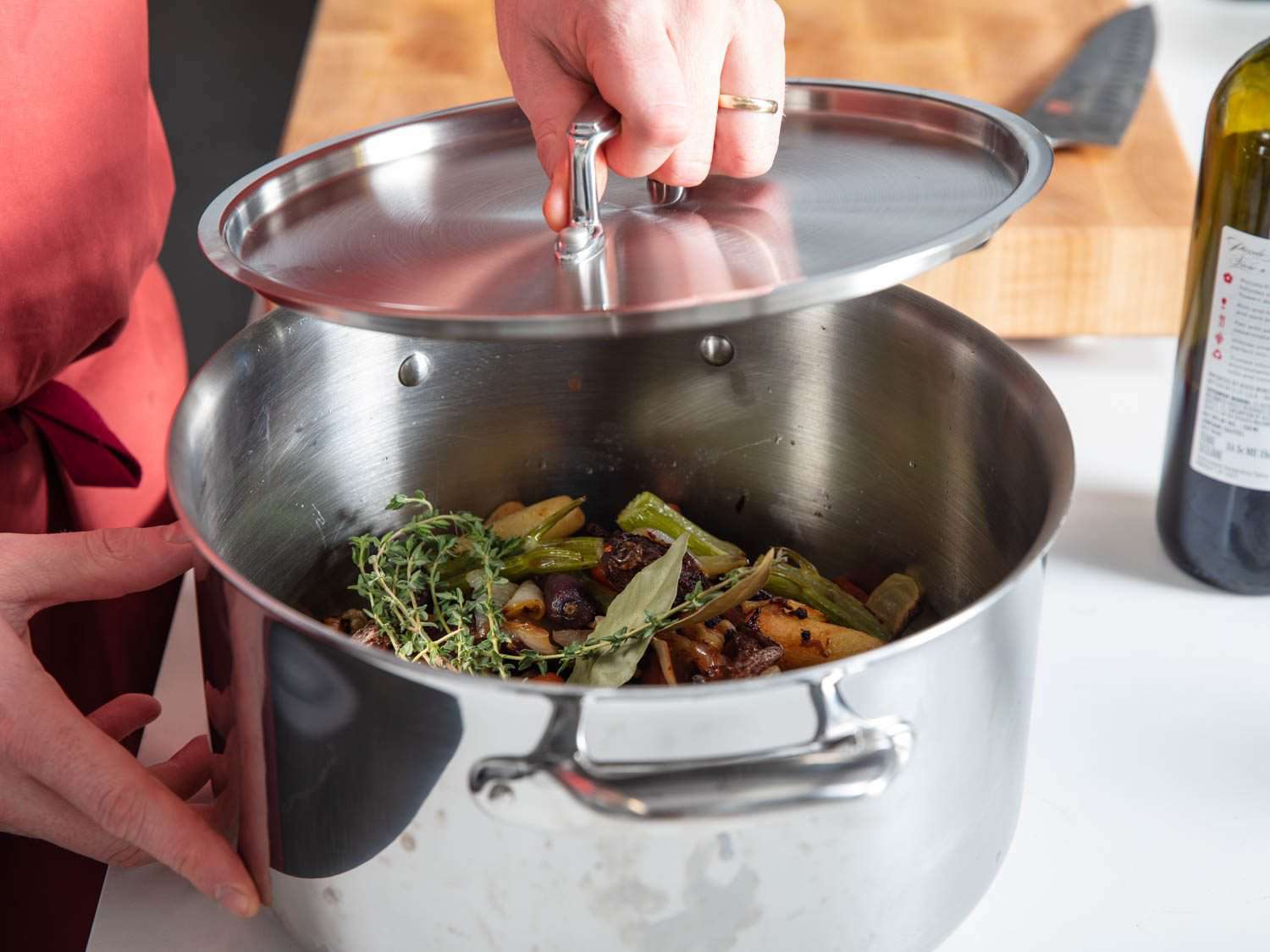 Popping a lid on a stockpot with all ingredients for duck stock except for water. Stockpot can be refrigerated until you are ready to make stock and then all you need to do is add water and cook on the stovetop.