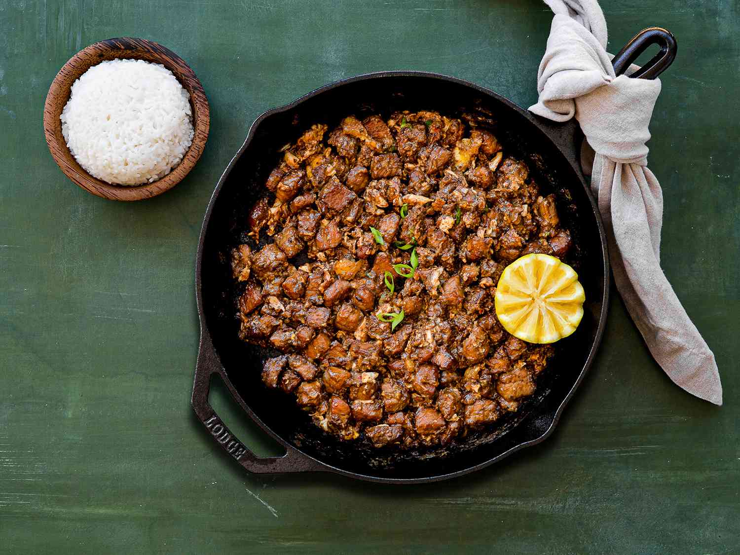 A cast iron skill of sizzling pork sisig