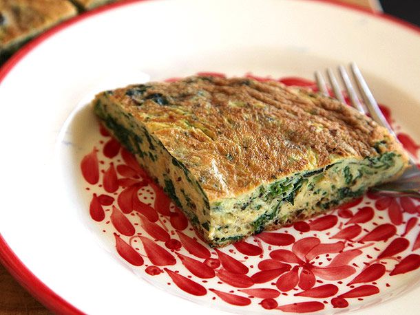 A quarter of the frittata, served on a painted plate.