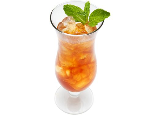 A Planter's Punch with a mint leaf garnish. 