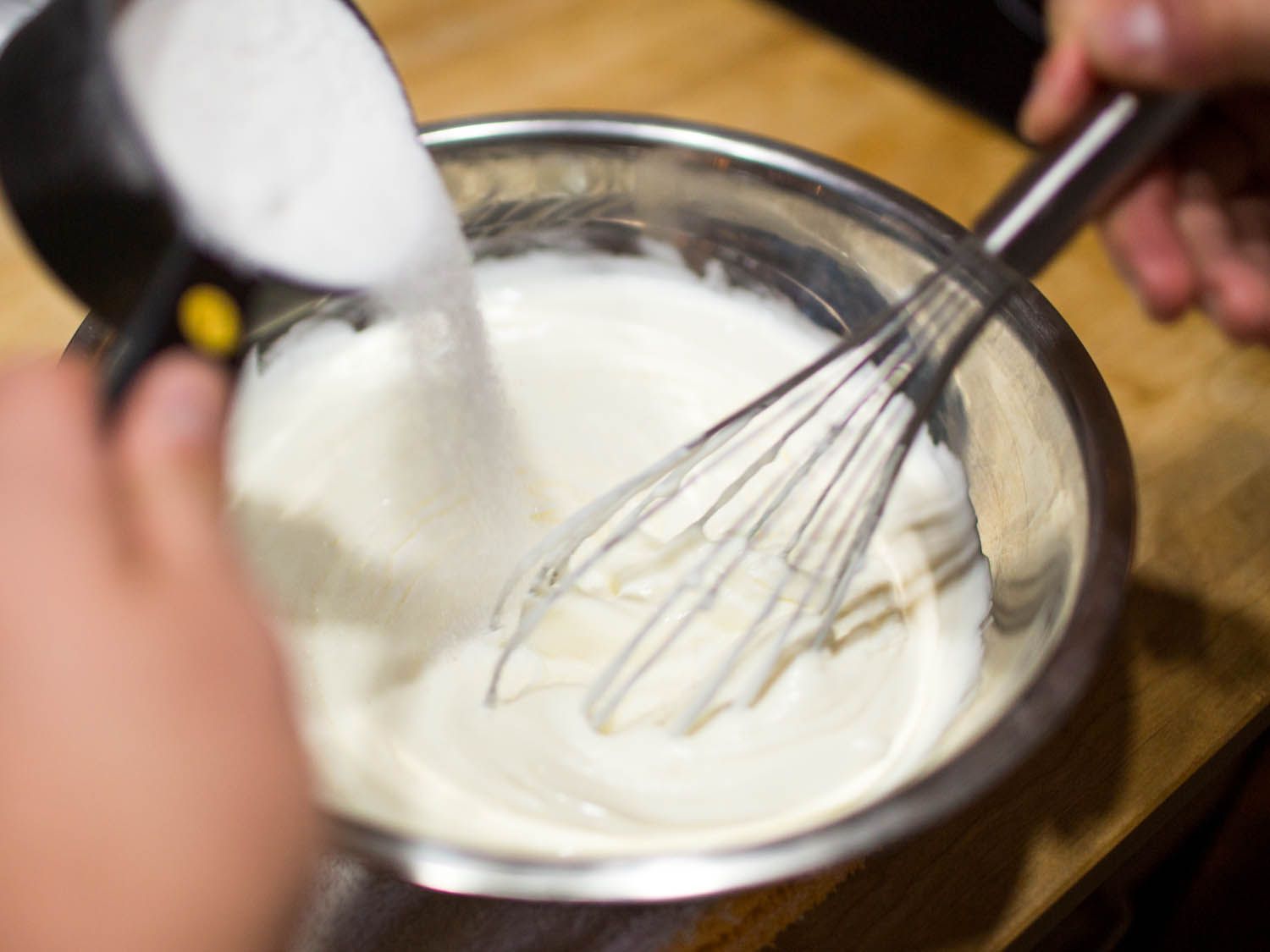 Whisking sugar into plain full fat yogurt.