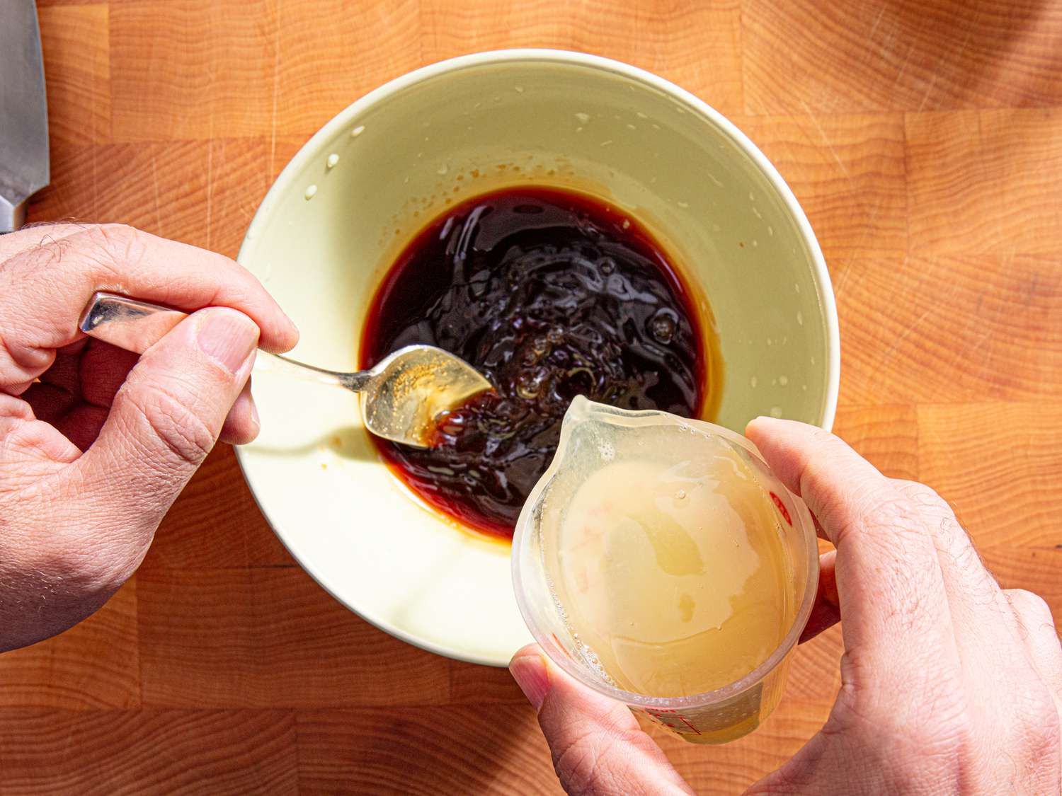 Overhead view of pouring lemon into coffee