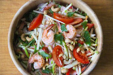 An overhead view of spicy shrimp and green apple salad in a bowl.