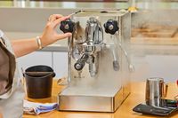 A hand turning a nob on the Lelit MaraX Espresso Machine PL62X-120