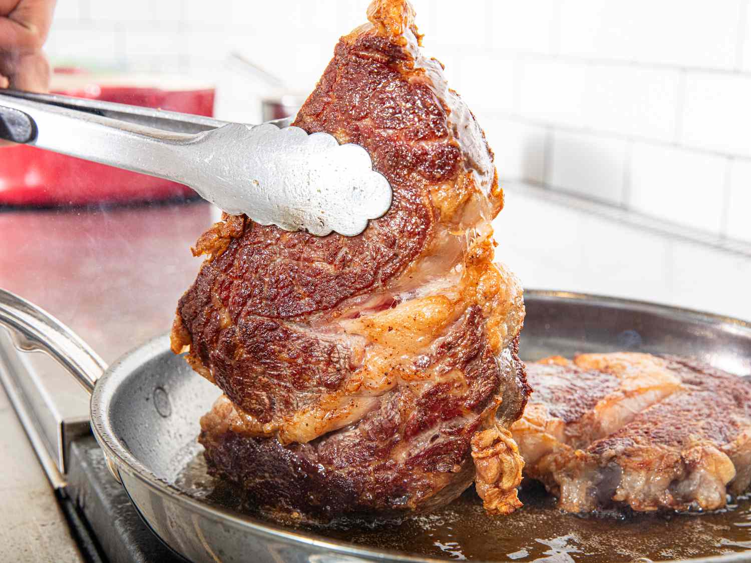 side view of searing steaks