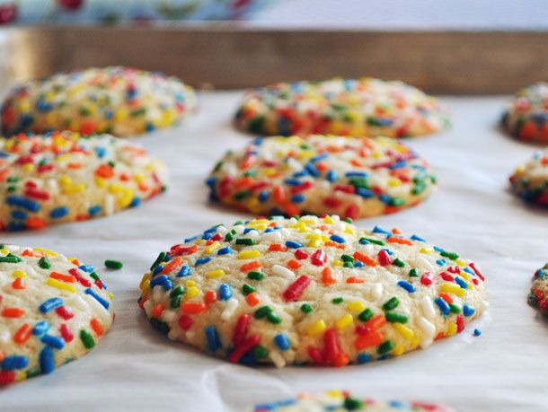 Close up view of vanilla sprinkle cookies on a baking sheet.