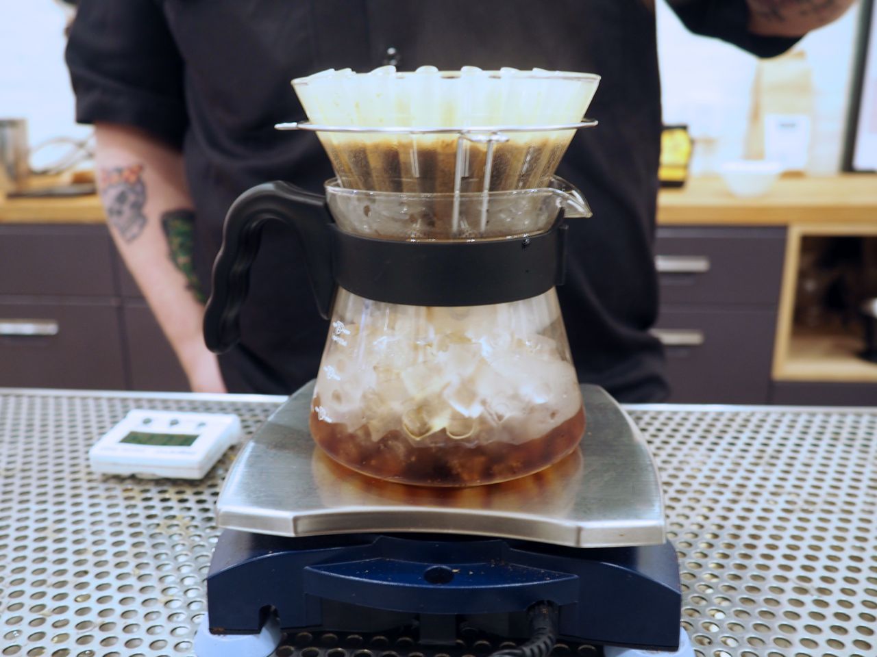 Iced coffee made in the Japanese style by brewing over a carafe of ice on a sacle.