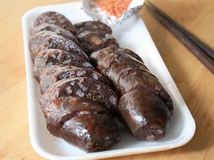 Korean blood sausages sliced on a rectangular white plate. 