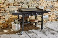 The Blackstone 1554 Cooking 4 Burner Flat Top Gas Grill outside on a patio