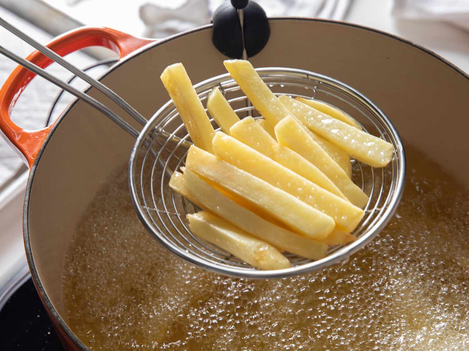 The French fries after their first fry: still pale in color and not crispy.